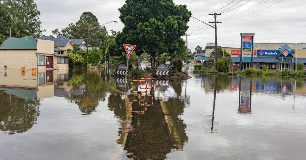 Tradespeople repairing property damaged by natural disaster