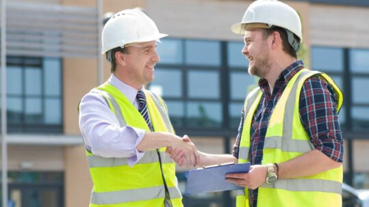 Construction contractors collaborating on a project site to improve performance and efficiency.