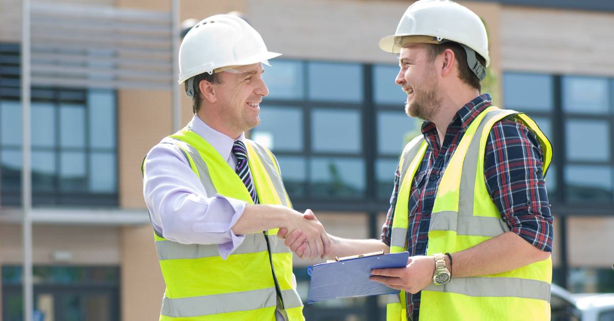 Construction contractors collaborating on a project site to improve performance and efficiency.